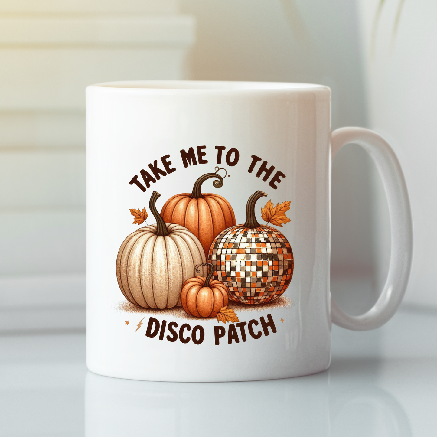 The Take Me to the Disco Patch Mug is a funny fall pumpkin gift featuring three pumpkins, a disco ball pumpkin, and the phrase "Take me to the disco patch"—a perfect retro autumn coffee mug for the season.