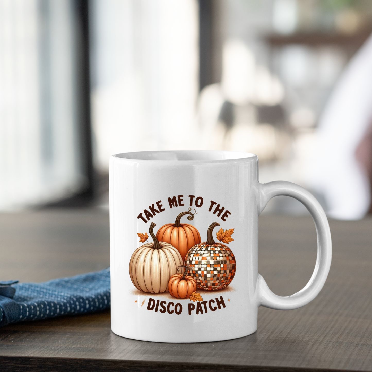 The Take Me to the Disco Patch Mug is a white retro autumn mug with pumpkins and a disco ball, plus the phrase "TAKE ME TO THE DISCO PATCH"—the perfect funny fall pumpkin gift for cozy coffee moments.