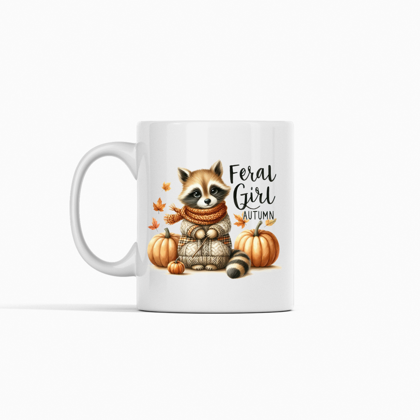 The Feral Girl Autumn Mug is a cozy fall coffee cup featuring a raccoon in a scarf and sweater among pumpkins and leaves, with “Feral Girl Autumn” text. Perfect for autumn vibes!.