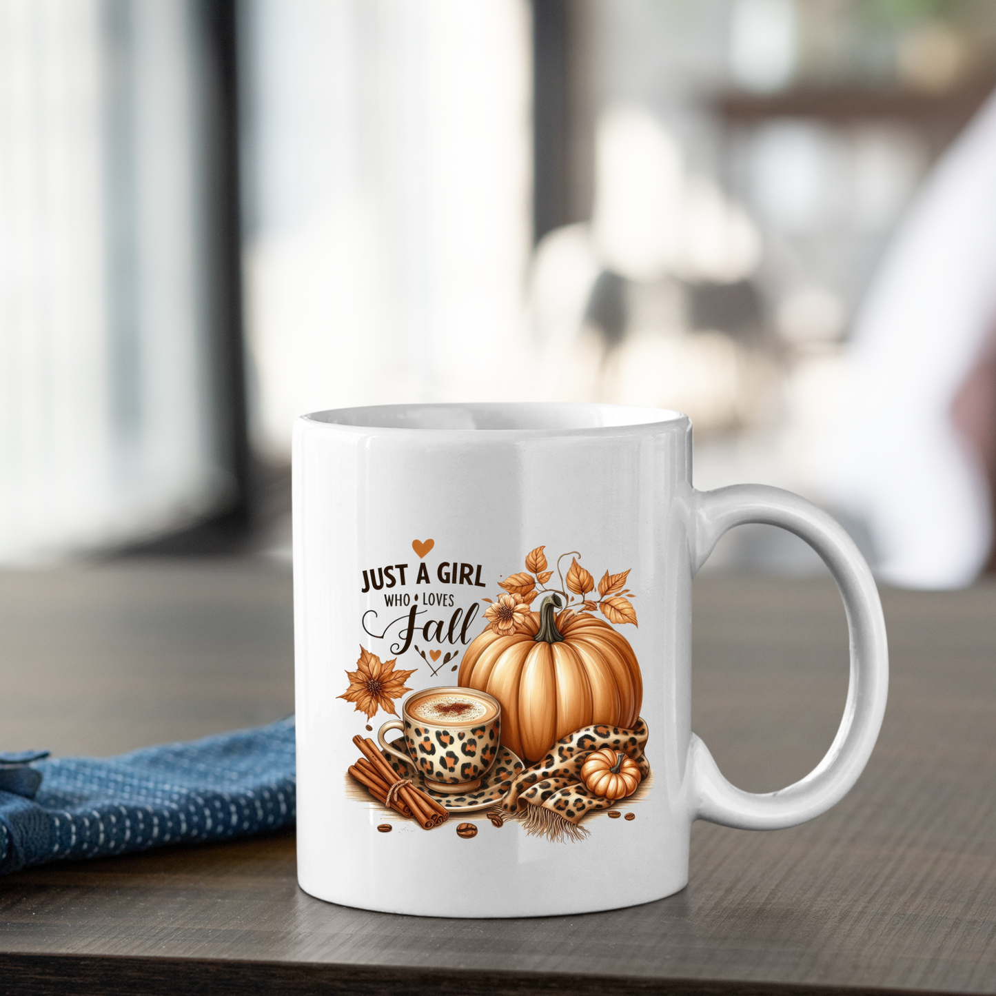 The Just a Girl Who Loves Fall Mug | Leopard Print Autumn Coffee Cup is a white mug featuring autumn artwork with pumpkins, cinnamon sticks, a leopard print coffee cup, leaves, and the phrase "Just a girl who loves fall.
