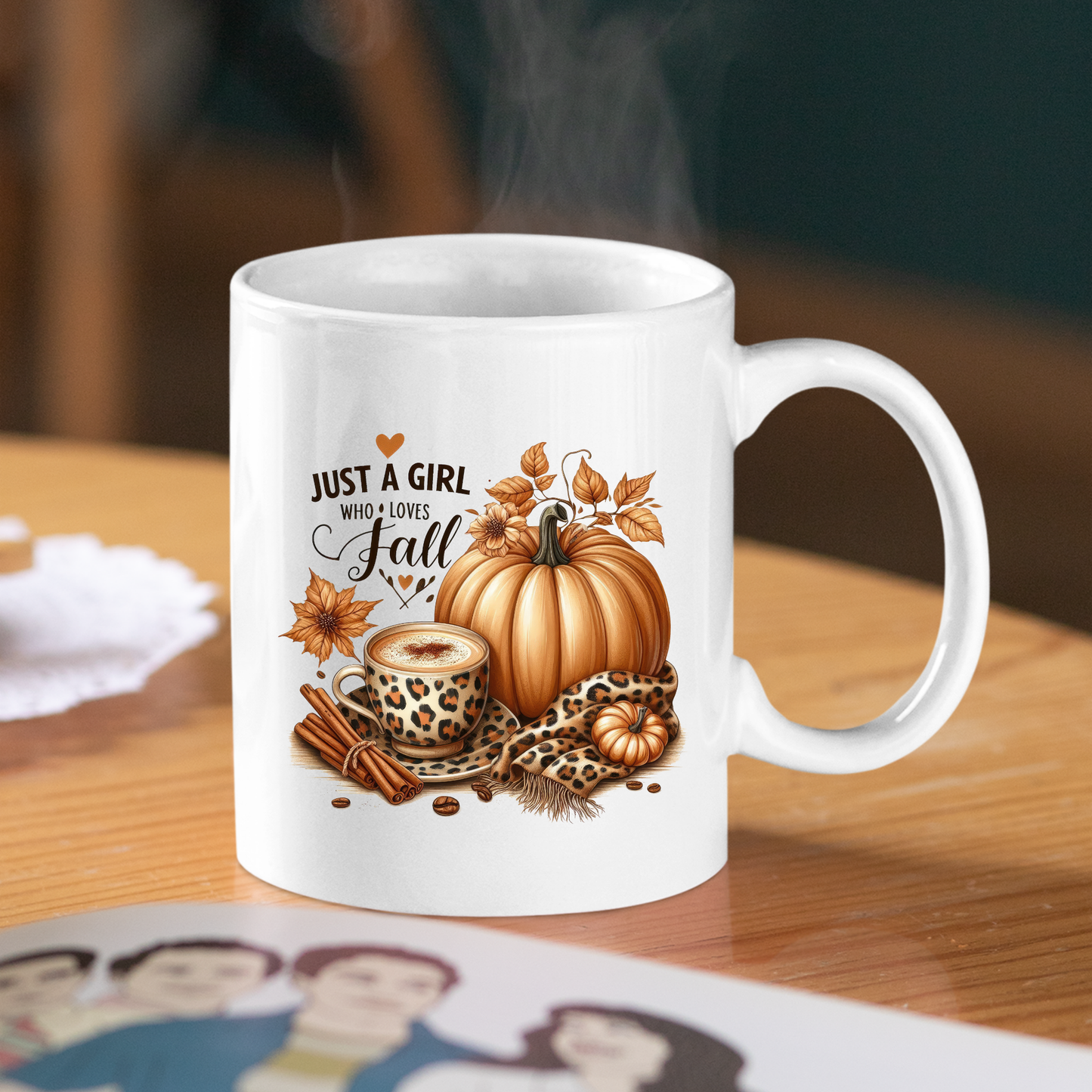 The Just a Girl Who Loves Fall Mug | Leopard Print Autumn Coffee Cup features autumn designs with pumpkins, leaves, cinnamon sticks, and leopard print. It sits steaming on a wooden table, perfect for fall lovers.
