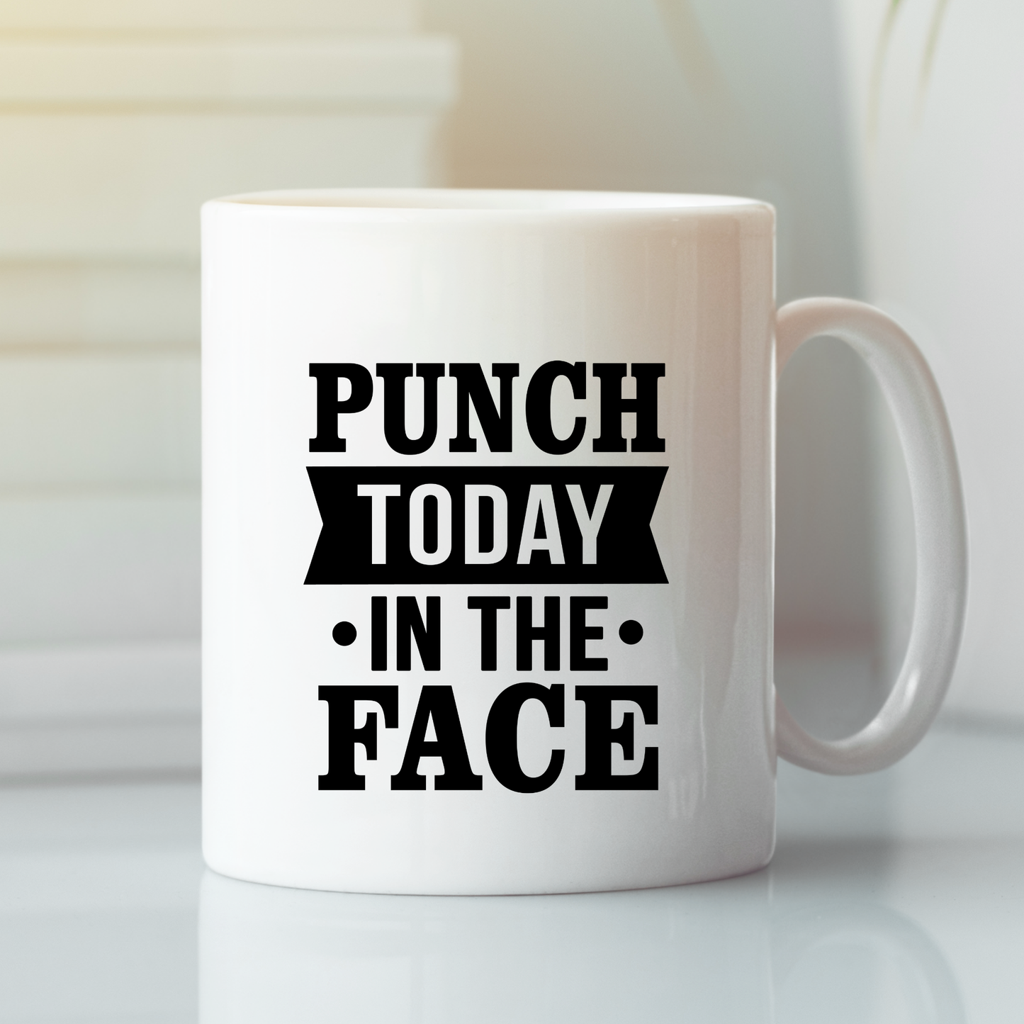 The Punch Today in the Face Mug | Bold Motivational Coffee Cup features striking black text and sits on a sleek surface with a blurred background—perfect for motivating your daily routine.