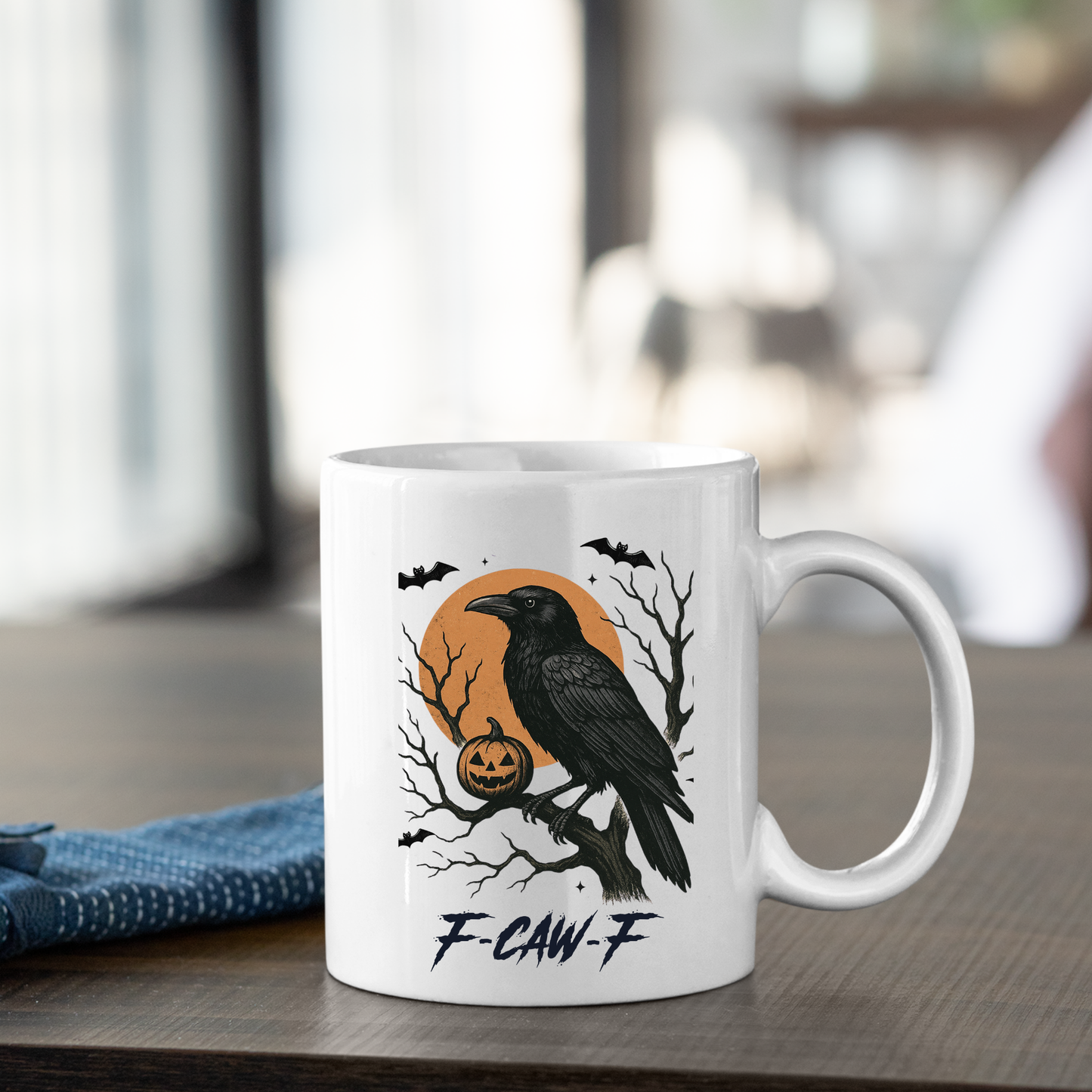 The F-CAW-F Raven Mug | Gothic Halloween Coffee Cup features a black raven, pumpkin, bats, and an orange moon with “F-CAW-F” text below. A unique Halloween gift for any coffee lover.