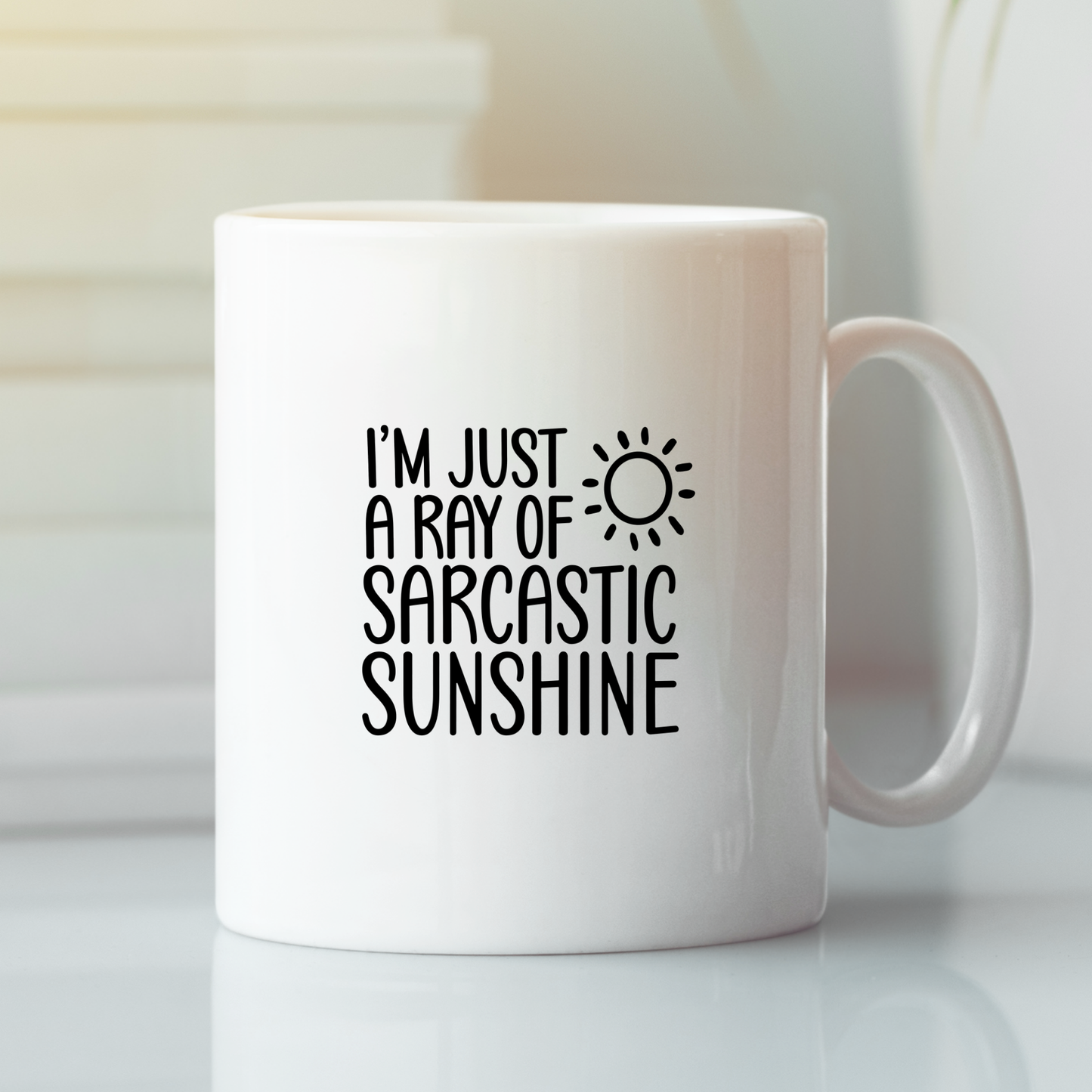 The Sarcastic Sunshine Mug | Funny Coffee Gift for Snarky People features "I’m just a ray of sarcastic sunshine" and a sun graphic in black. This white mug is a perfect funny gift for coworkers and stands out on any desk.