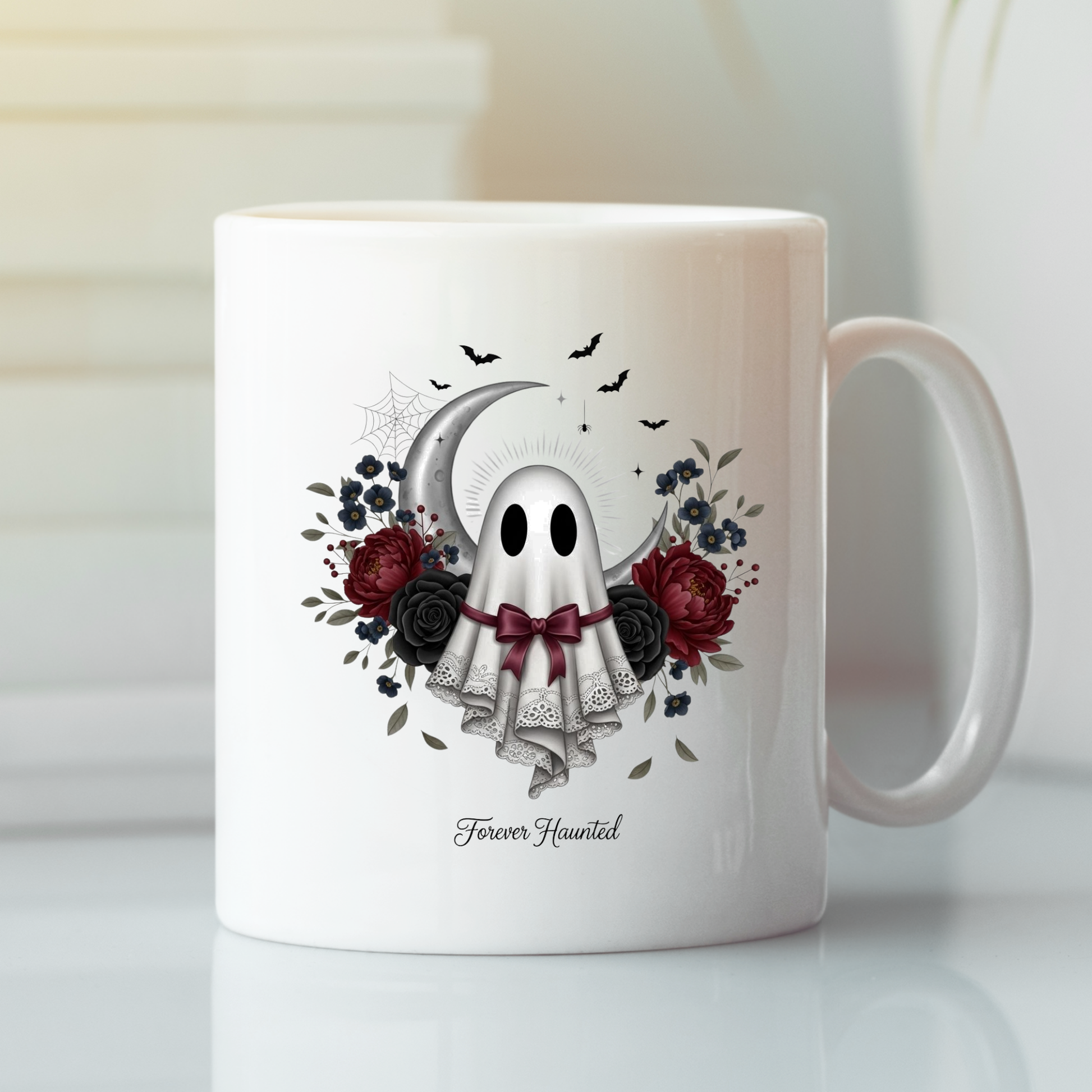 A white Forever Haunted Ghost Mug | Gothic Halloween Coffee Mug featuring a cute ghost with a lace veil, surrounded by red and blue flowers, bats, and a crescent moon. The text below reads “Forever Haunted.”.