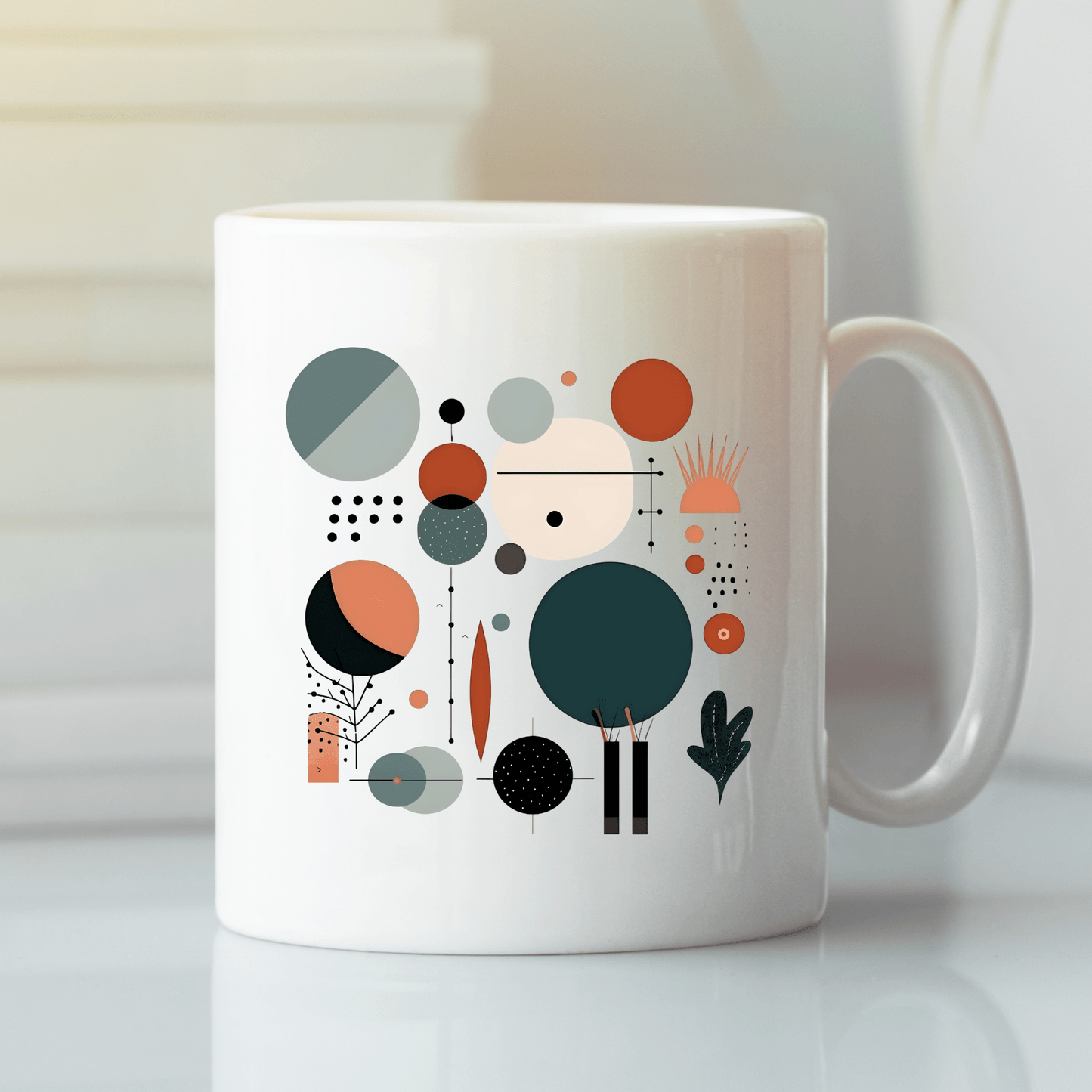 The Harvest Sun Mid Century Modern Mug is a white ceramic mug with a retro geometric design of circles, lines, dots, and leaf shapes in teal, orange, black, and beige. It rests on a smooth white surface.