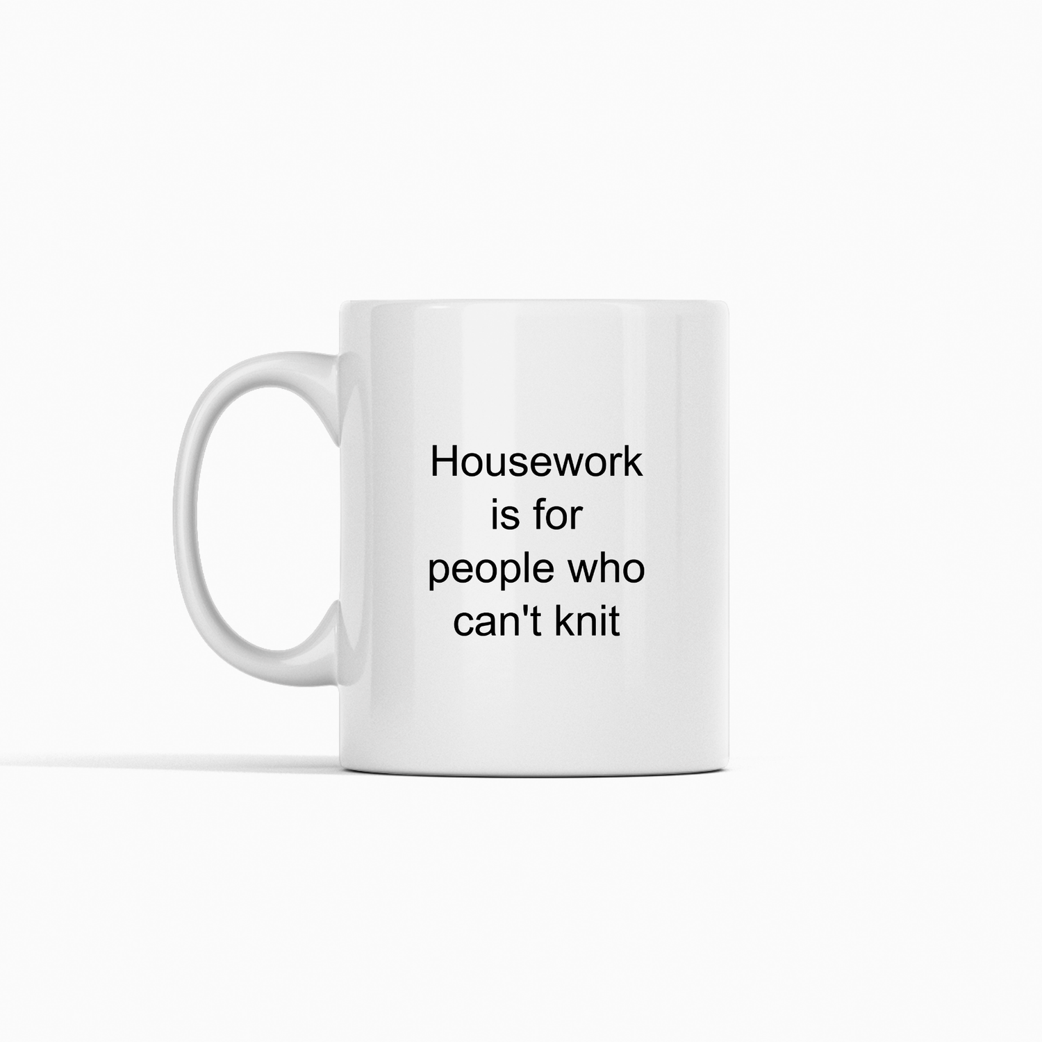 The Housework Is for People Who Can’t Knit Mug | Knitting Gift is a white ceramic mug with black text, perfect for knitters and displayed against a plain white background.