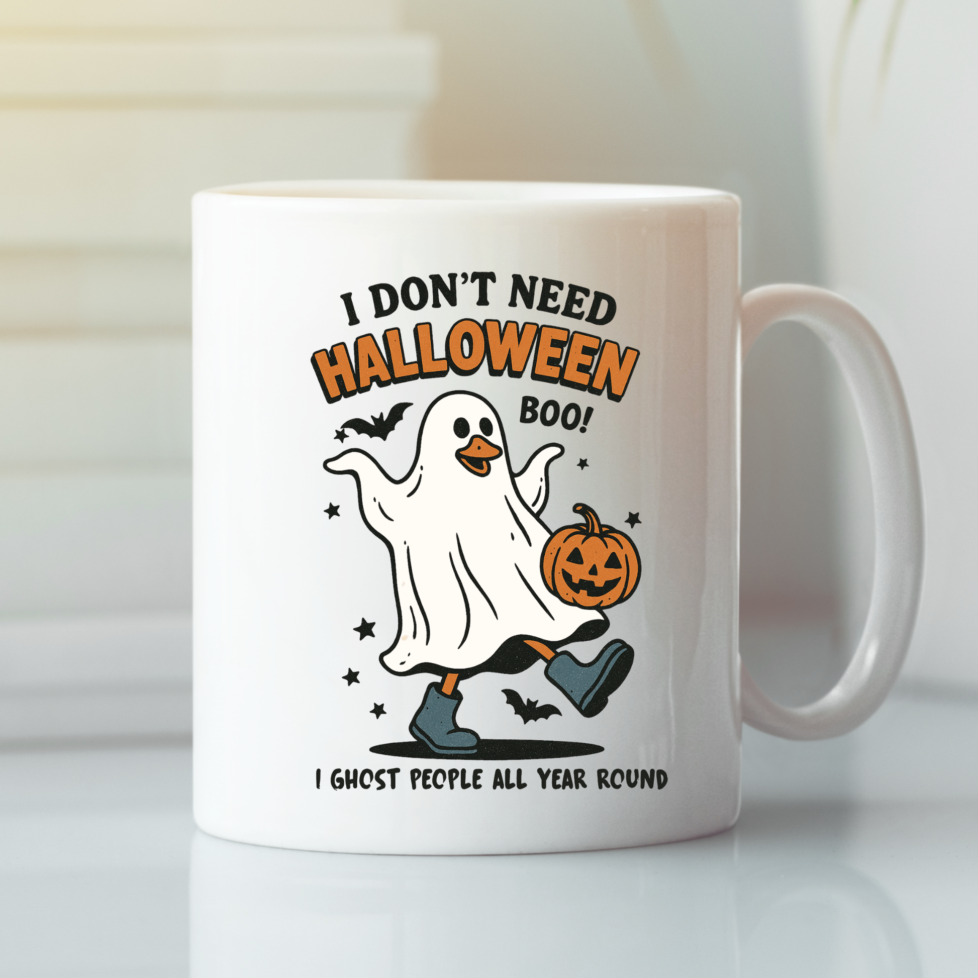 The Funny Ghost Mug | I Don’t Need Halloween Boo Cup shows a cute ghost in blue boots with a pumpkin, bats, and the phrases “I DON’T NEED HALLOWEEN BOO!” and “I GHOST PEOPLE ALL YEAR ROUND.” Perfect for spooky coffee lovers.