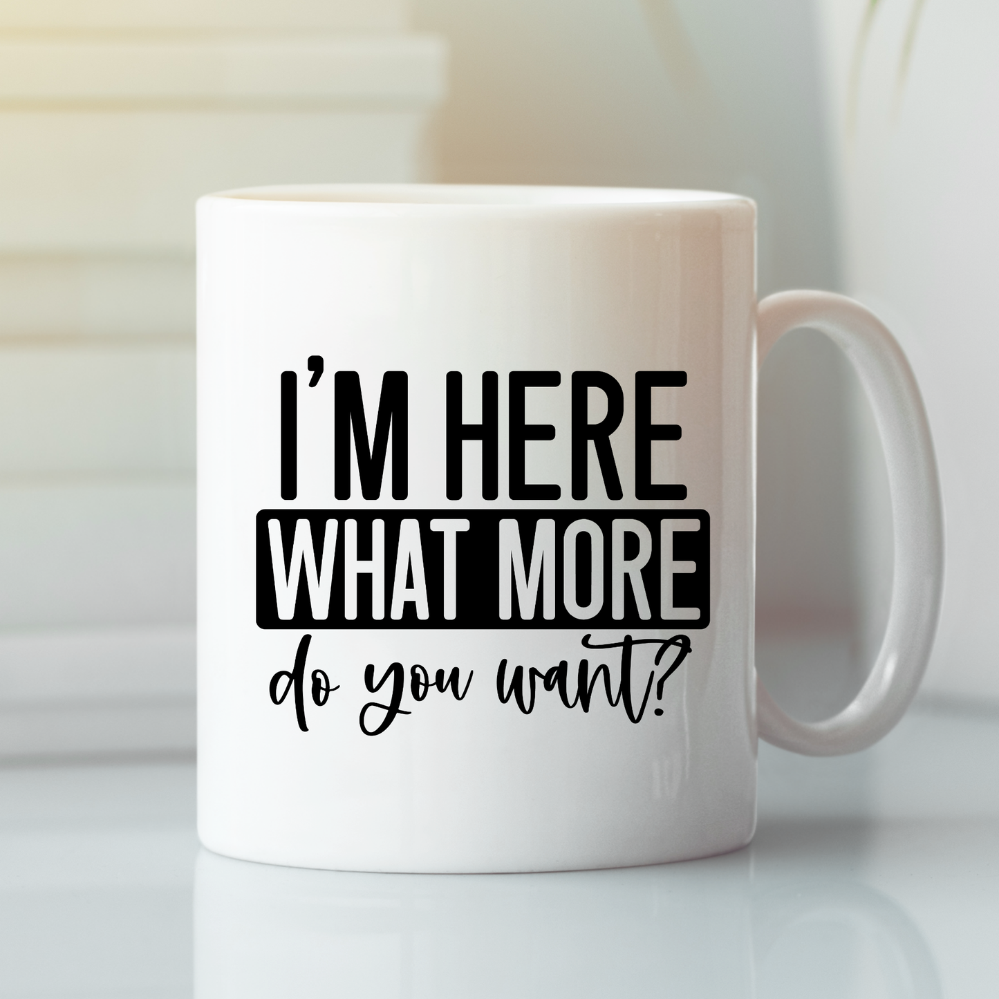 The I’m Here What More Do You Want Mug is a funny, sarcastic coffee cup featuring bold black text—great for introverts and perfect as a quirky gift.