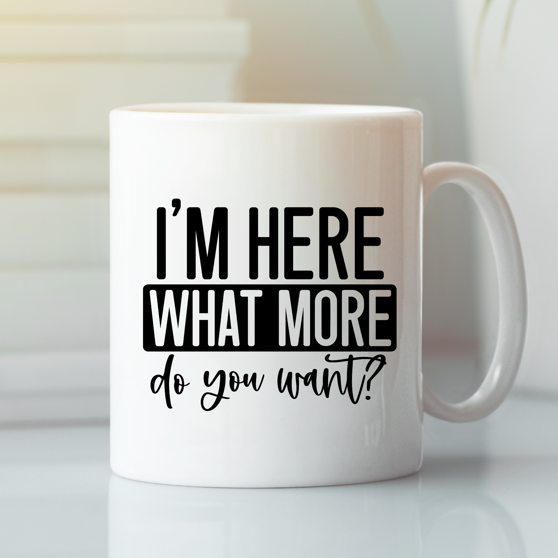 The I’m Here What More Do You Want Mug is a funny, sarcastic coffee cup featuring bold black text—great for introverts and perfect as a quirky gift.