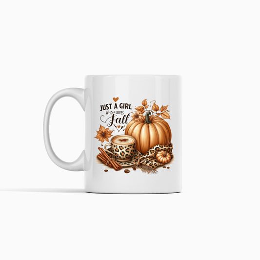 The Just a Girl Who Loves Fall Mug is an autumn-themed coffee cup featuring pumpkins, leaves, a leopard print mug of pumpkin spice, and "Just a girl who loves fall" in black lettering with a heart.