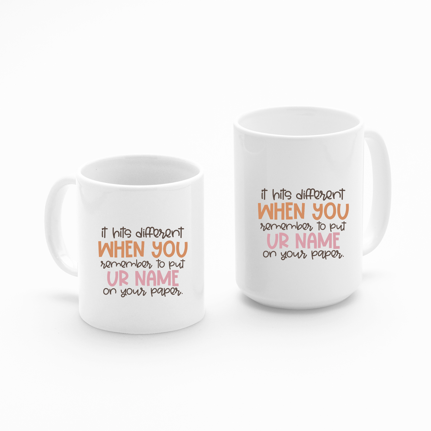 The Put Your Name On Your Paper Mug features the phrase "It hits different when you remember to put ur name on your paper," with "when you" in orange and "ur name" in pink—a funny teacher gift or classroom humor mug.