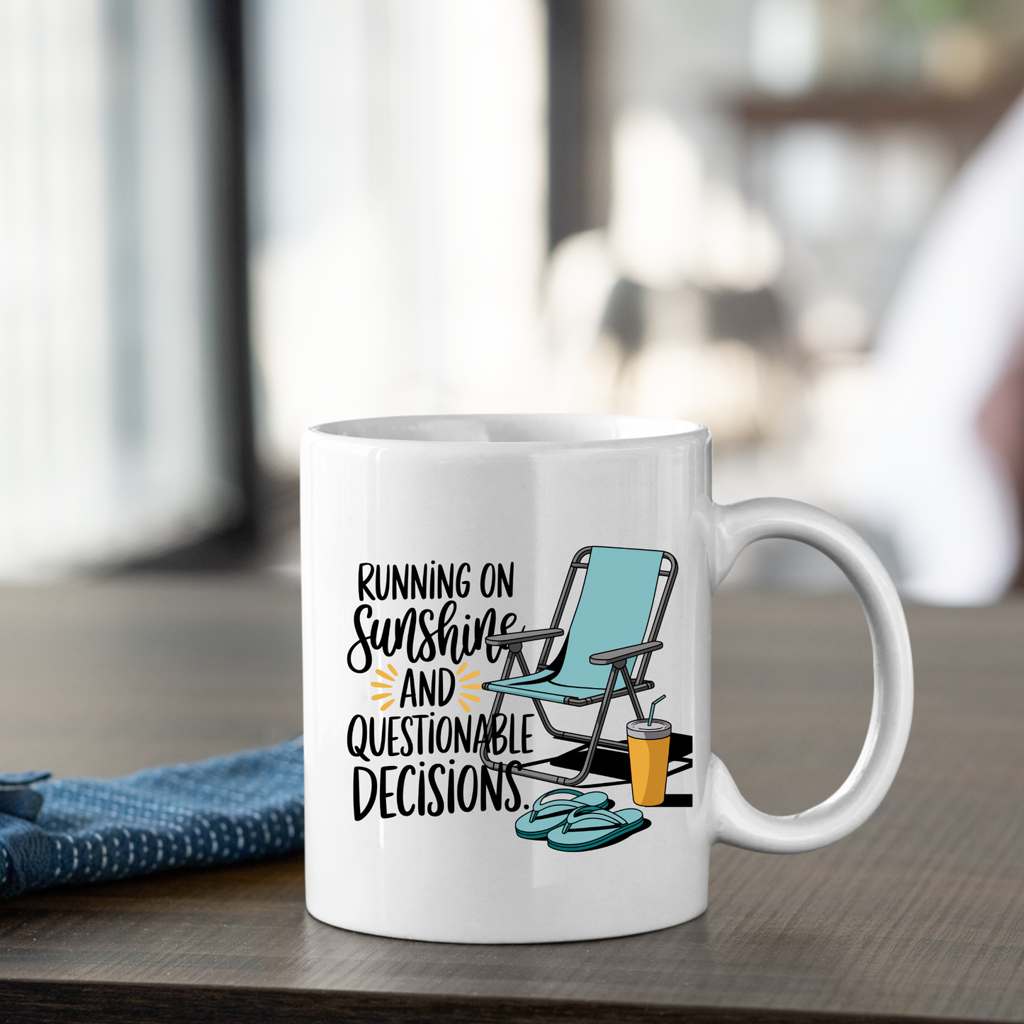 The Running on Sunshine Mug | Funny Beach Lover Gift sits on a table, featuring an illustration of a beach chair, sandals, and a drink. The mug displays the phrase: “Running on sunshine and questionable decisions.” This charming vacation coffee mug brings laid-back vibes to your mornings against a softly blurred indoor background.