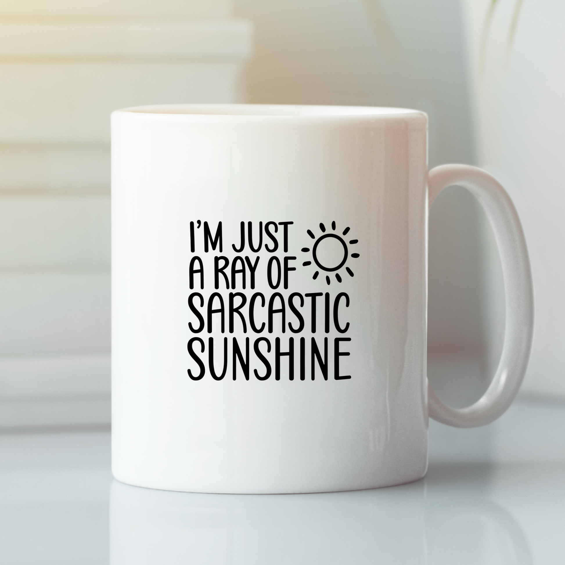 The Sarcastic Sunshine Mug | Funny Coffee Gift for Snarky People features "I’m just a ray of sarcastic sunshine" and a sun graphic in black. This white mug is a perfect funny gift for coworkers and stands out on any desk.