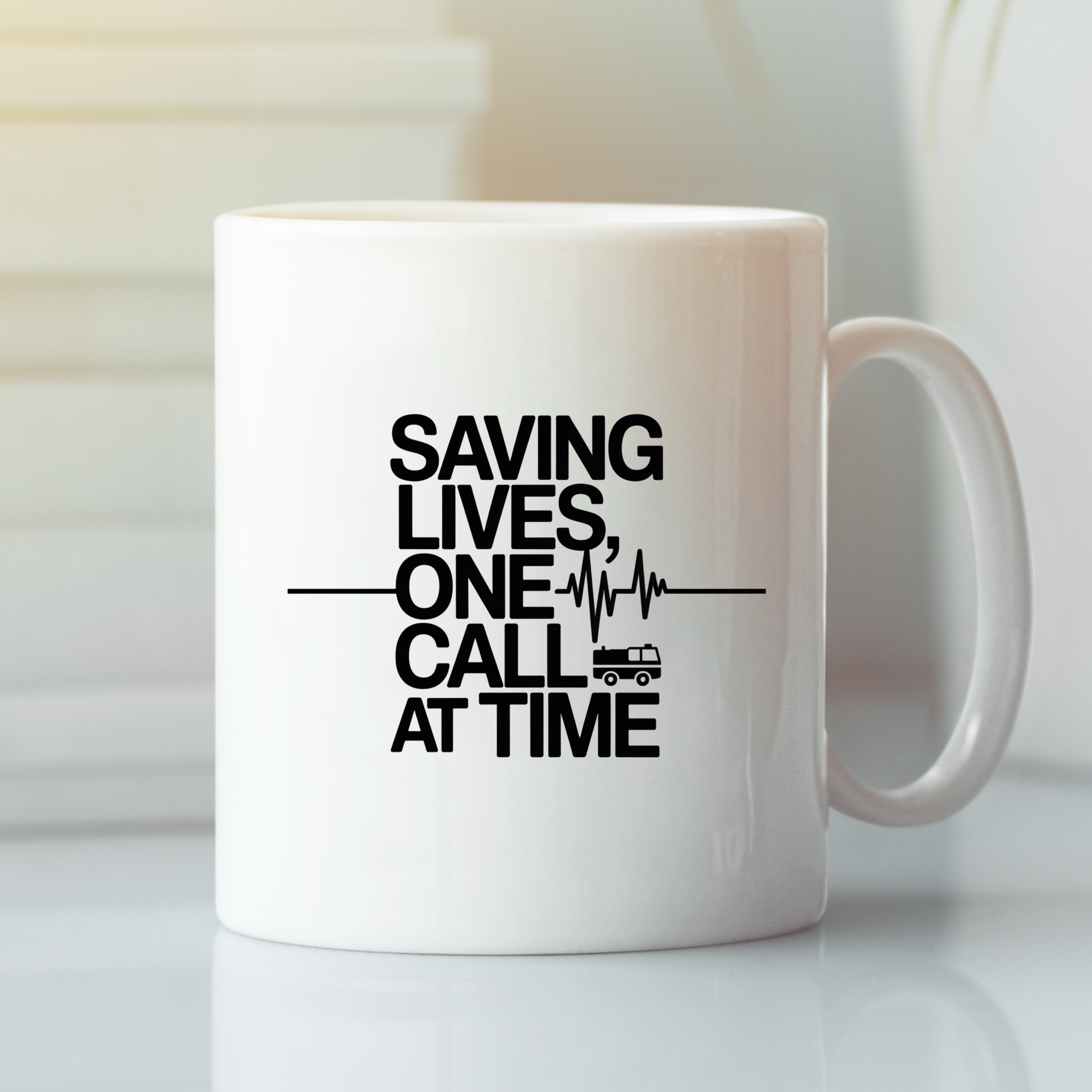 Introducing the Saving Lives One Call at a Time EMT Mug: a white mug featuring the bold black message "SAVING LIVES, ONE CALL AT A TIME," accented with a heart rate line graphic and a small ambulance icon underneath. It's the perfect choice for EMTs and makes a thoughtful gift for any paramedic.