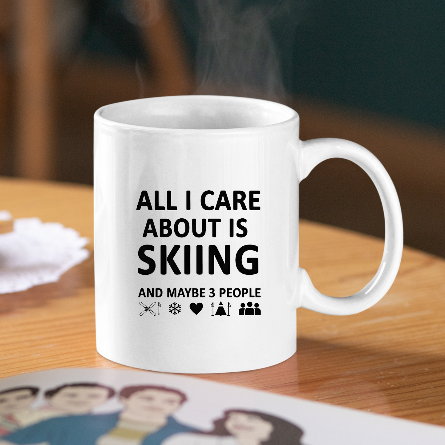 The Skiing and Three People Mug – Funny Coffee Cup sits on a wooden table, featuring black text: "All I care about is skiing and maybe 3 people," with ski poles, a snowflake, heart, skier, and three people—perfect for introverted skiers.