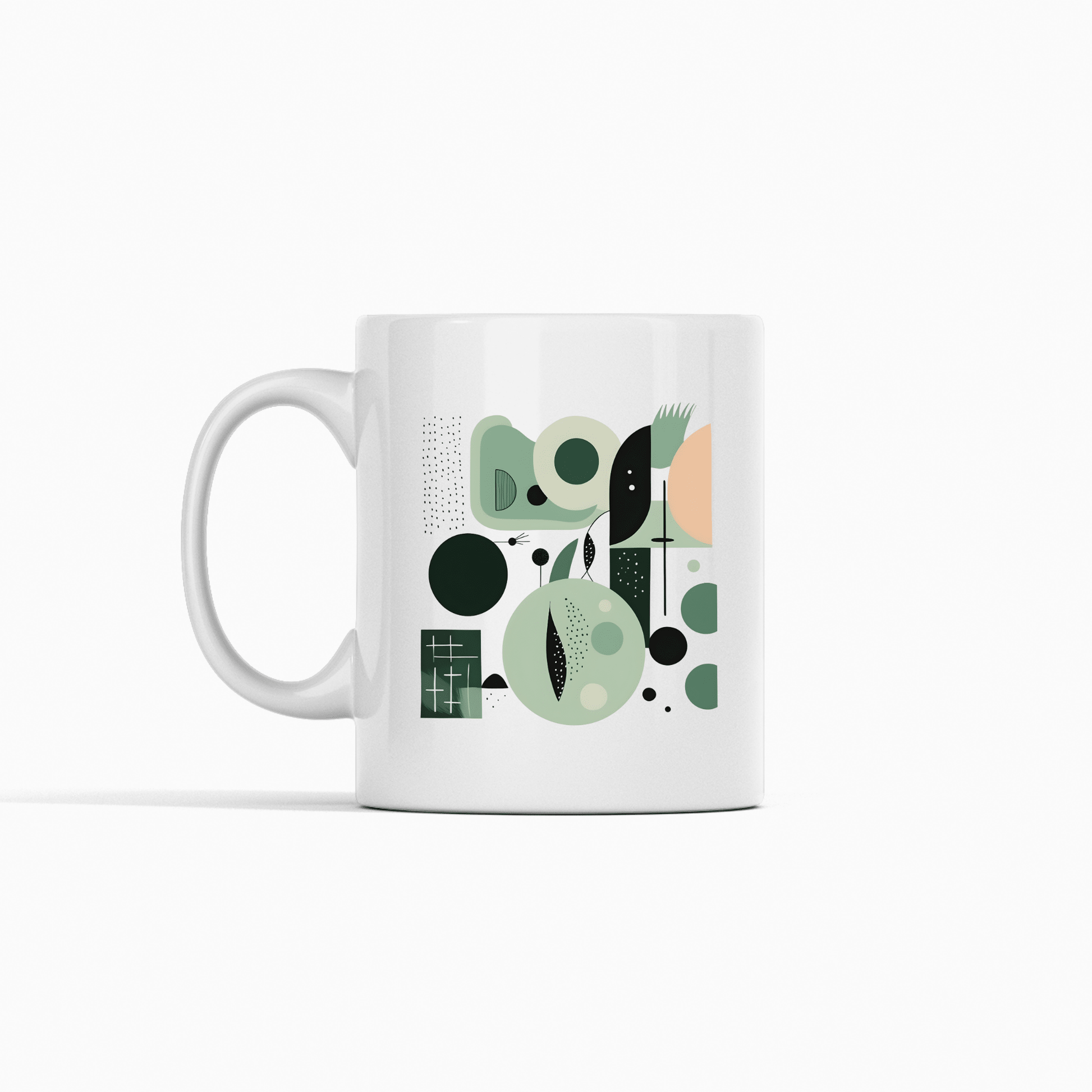 The Spring Geometry Mid Century Modern Mug is a white ceramic mug featuring an abstract green, black, and peach geometric design—circles, rectangles, and lines—set against a plain white background.