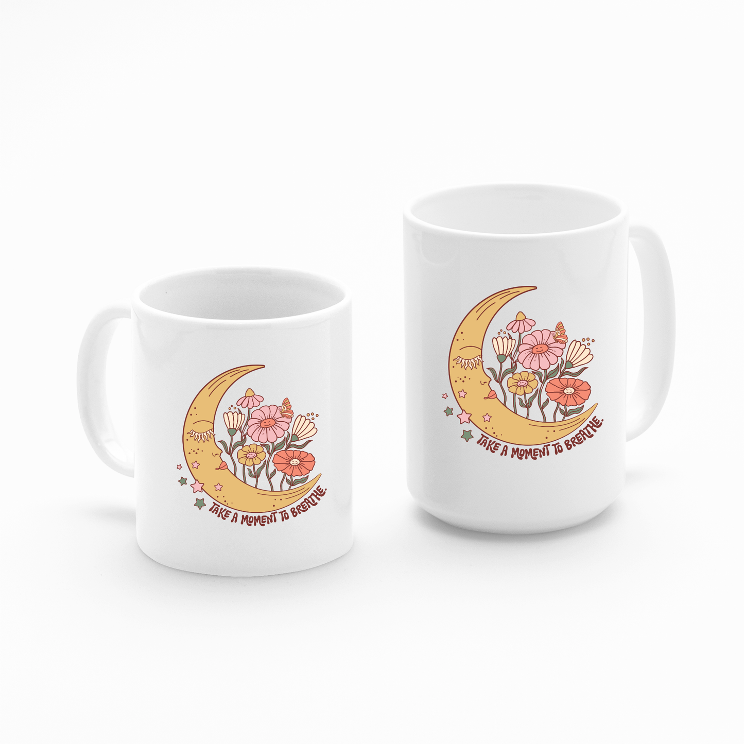 Set of two white "Take a Moment to Breathe Mug | Mindfulness Coffee Mug" designs featuring a crescent moon, pink and orange flowers, and stars. Both mugs display the uplifting message "Take a moment to breathe," making them ideal for self care gifts or as meditation mugs.